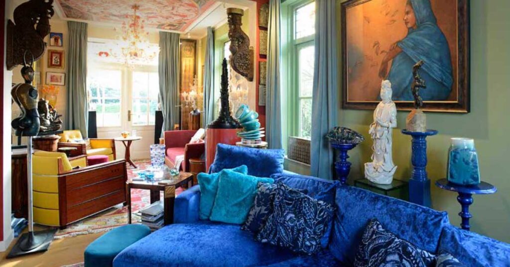 A cozy living room with blue couches and blue artwork, highlighting the connection between beauty and happiness in science.